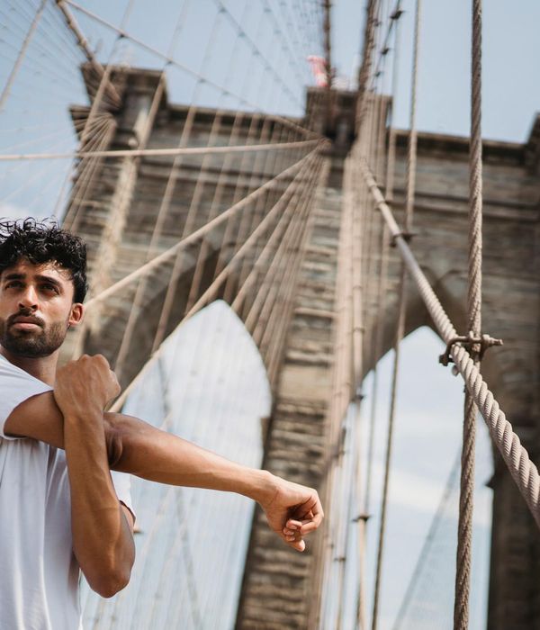Person stretching outdoors during a sunrise, looking energized and refreshed.